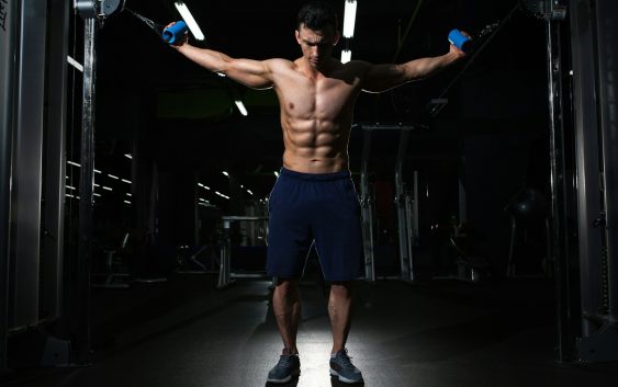 man exercising inside dim room